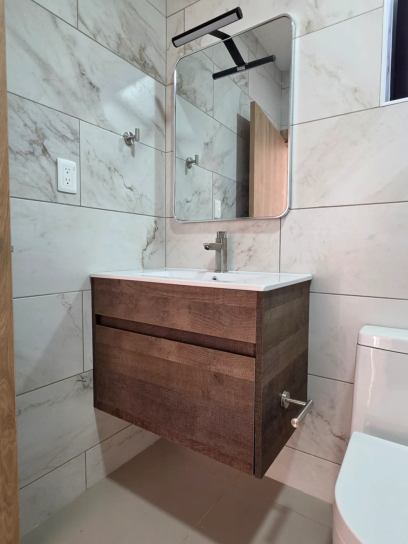 Floating woodgrain vanity with basin
