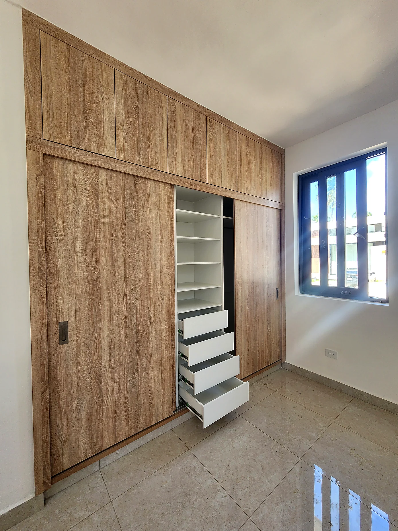 Built-in woodgrain sliding wardrobe with drawers